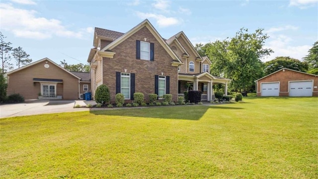 739 E Mays Rd E, Stockbridge, GA 30281 - traditional home featuring a garage, a front lawn, brick siding, and an outdoor structure