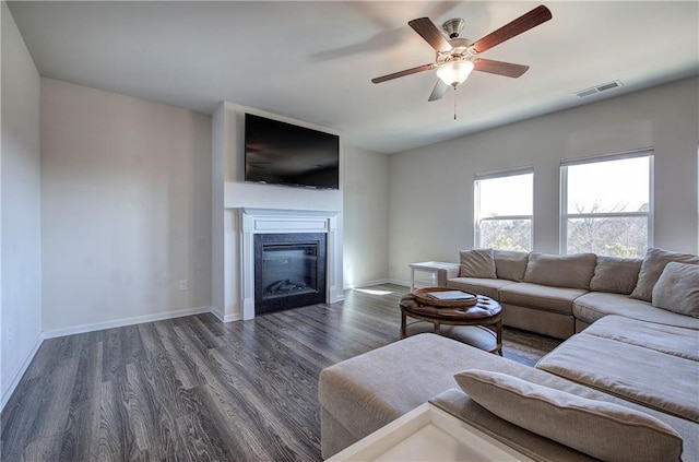 living room with ceiling fan and dark hardwood / wood-style floors