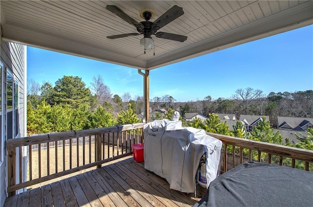 wooden terrace featuring area for grilling and ceiling fan