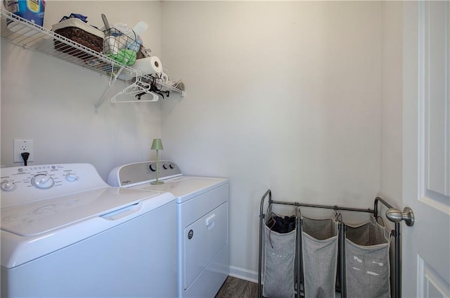 laundry area with laundry area, independent washer and dryer, and wood finished floors