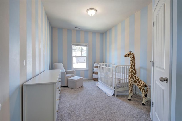 carpeted bedroom featuring a crib