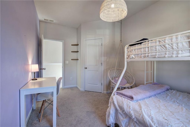 carpeted bedroom with baseboards and visible vents