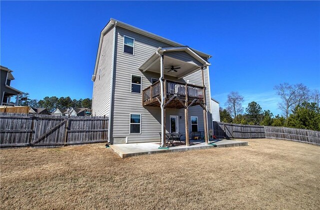 rear view of property with a patio, a balcony, a fenced backyard, and ceiling fan