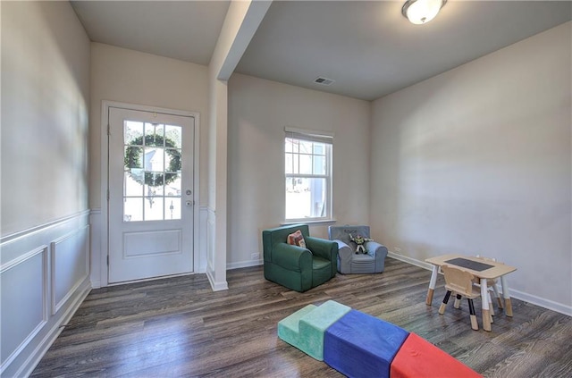 interior space with visible vents, plenty of natural light, and wood finished floors