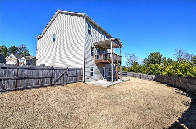 back of house with a fenced backyard, a patio, a yard, and ceiling fan