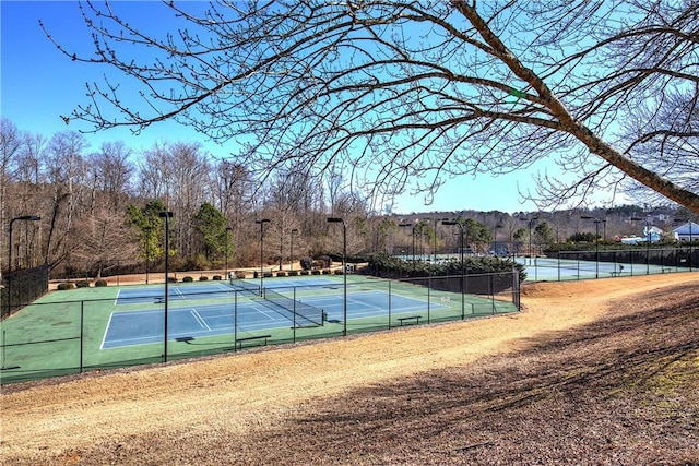 view of sport court featuring fence