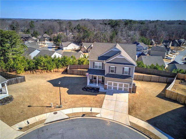 birds eye view of property featuring a forest view and a residential view