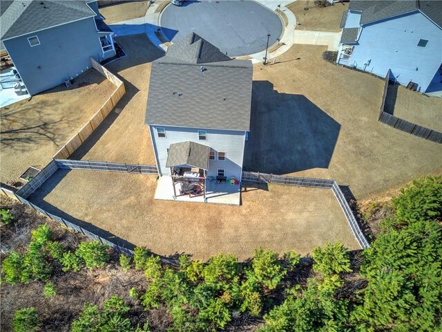 birds eye view of property with a forest view and a residential view