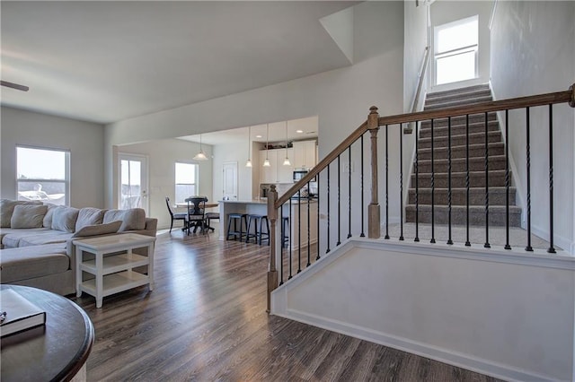 living area with stairs and wood finished floors