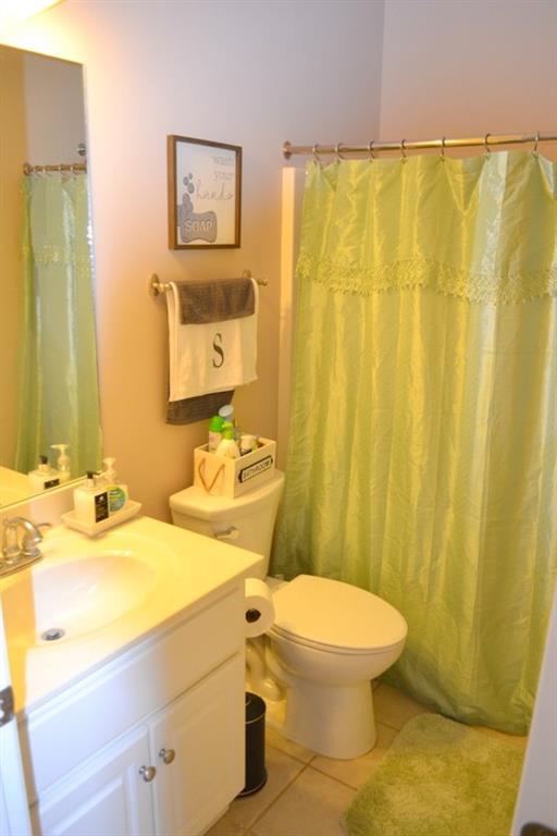 bathroom with tile patterned floors, toilet, and vanity