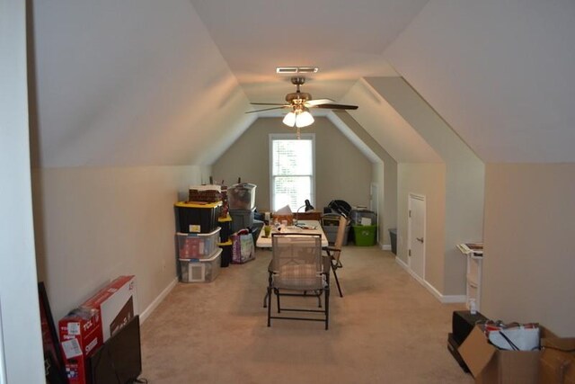 recreation room with ceiling fan, light colored carpet, and vaulted ceiling