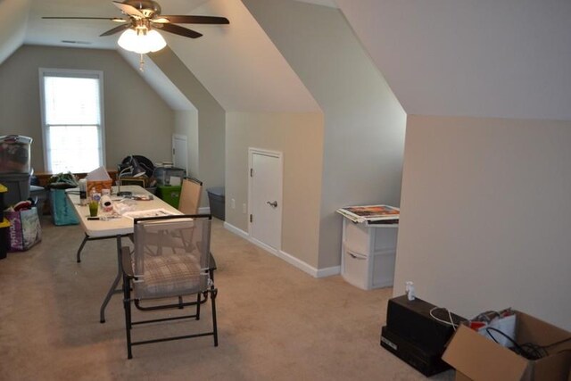 carpeted dining area with vaulted ceiling and ceiling fan