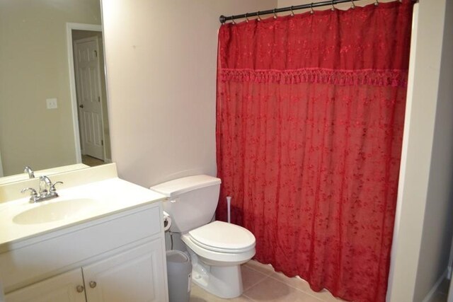 bathroom featuring vanity, toilet, tile patterned floors, and a shower with shower curtain