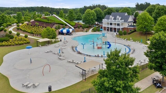 view of swimming pool with a patio area and a lawn