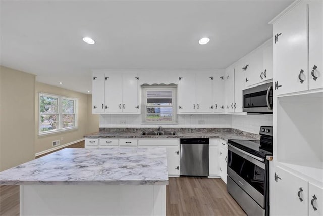 9258 Westview Dr SW, Covington, GA 30014 - kitchen with light wood-style flooring, a sink, stainless steel appliances, and decorative backsplash