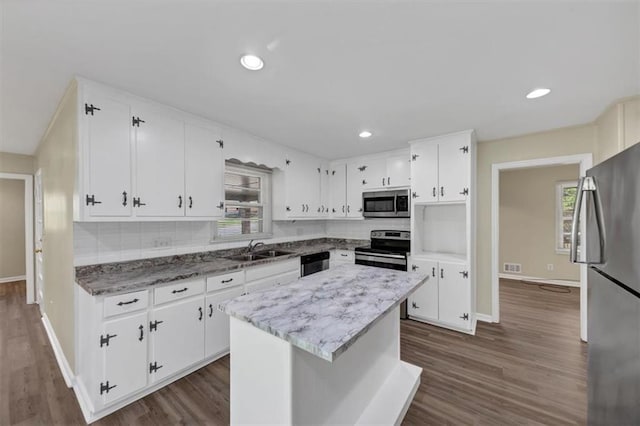 9258 Westview Dr SW, Covington, GA 30014 - kitchen with white cabinetry, a sink, stainless steel appliances, and tasteful backsplash