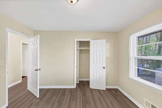 9258 Westview Dr SW, Covington, GA 30014 - unfurnished bedroom with wood finished floors, a closet, baseboards, and visible vents