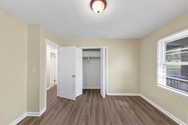 9258 Westview Dr SW, Covington, GA 30014 - unfurnished bedroom with a closet, baseboards, and wood finished floors