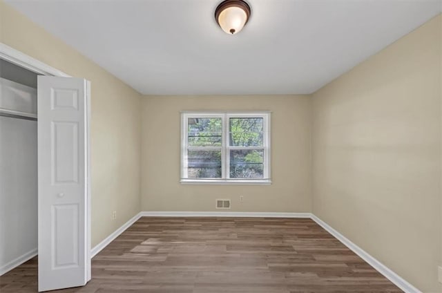 9258 Westview Dr SW, Covington, GA 30014 - unfurnished bedroom with baseboards, visible vents, and wood finished floors
