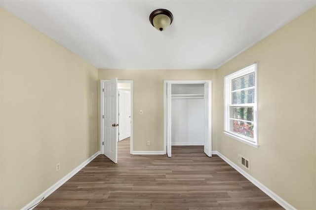 9258 Westview Dr SW, Covington, GA 30014 - unfurnished bedroom with a closet, baseboards, visible vents, and wood finished floors