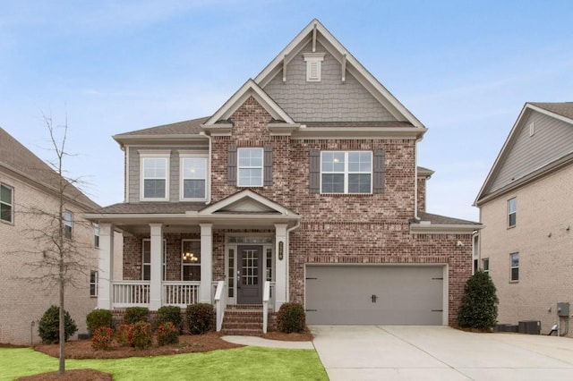 craftsman-style home with cooling unit, covered porch, a front yard, and a garage