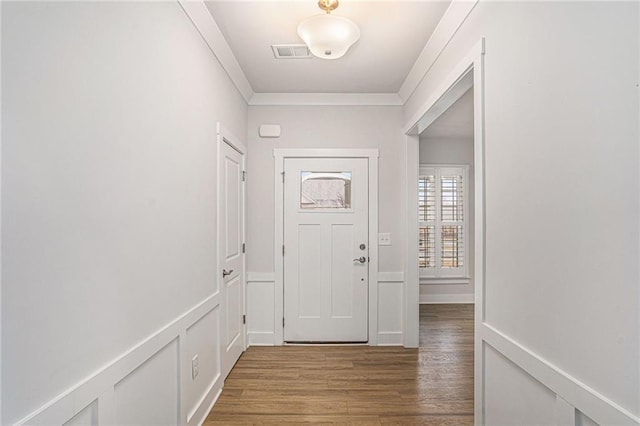 entryway with crown molding and hardwood / wood-style flooring