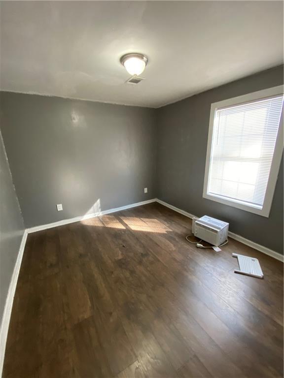 3734 Travis Blvd, Macon, GA 31206 - empty room featuring baseboards and dark wood finished floors