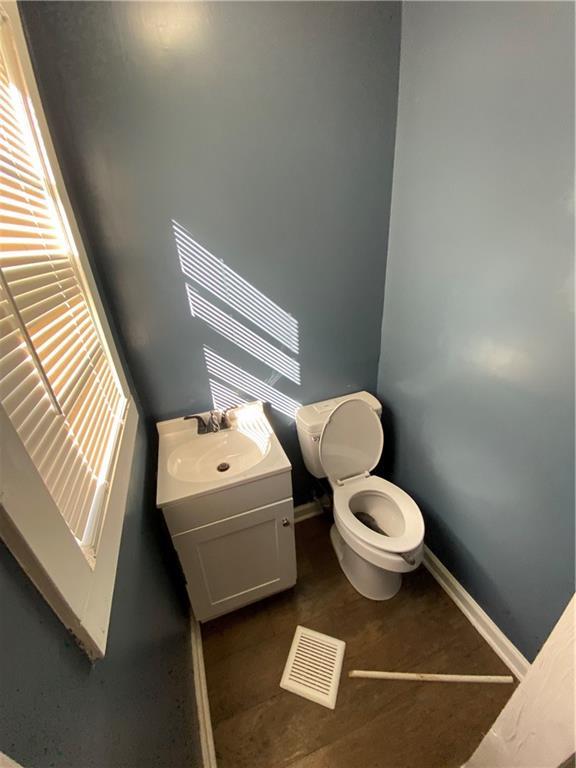 3734 Travis Blvd, Macon, GA 31206 - half bath featuring vanity, toilet, and baseboards