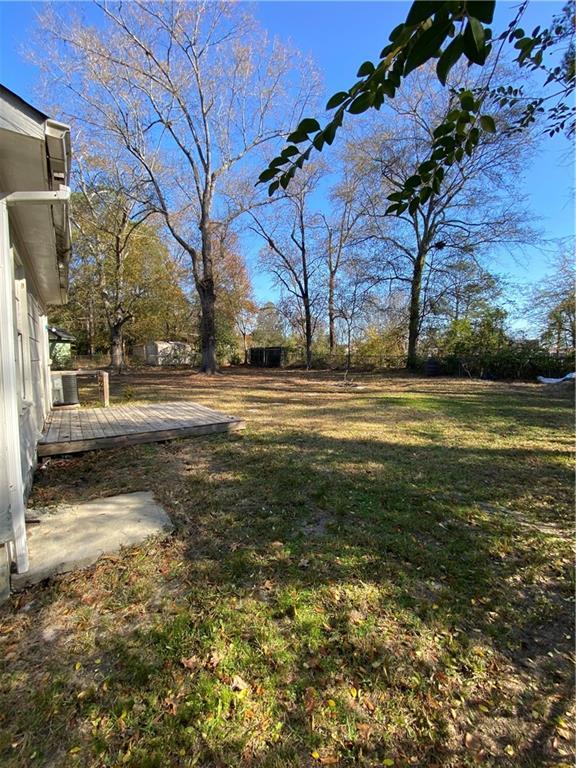 3734 Travis Blvd, Macon, GA 31206 - view of green lawn featuring a deck