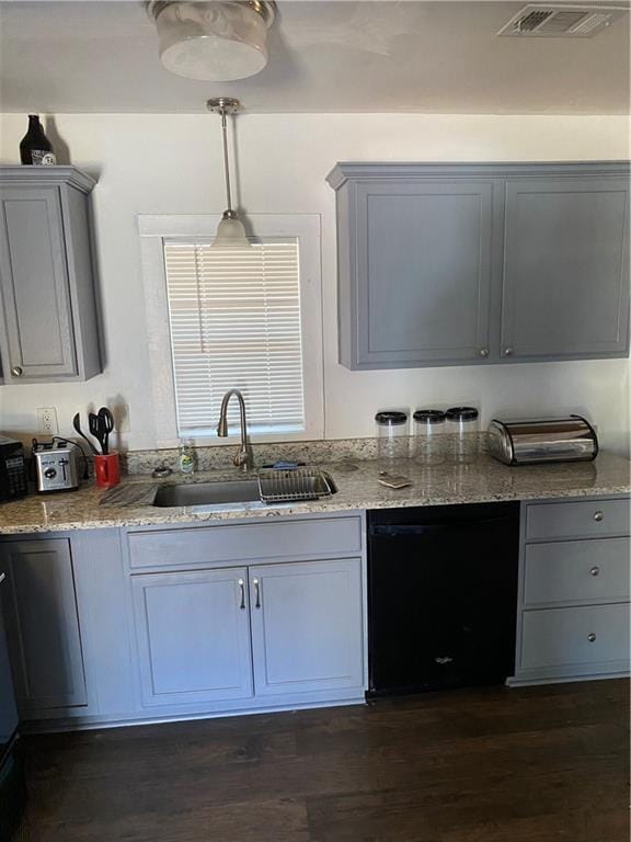 3734 Travis Blvd, Macon, GA 31206 - kitchen featuring black dishwasher, a sink, light stone counters, and gray cabinetry
