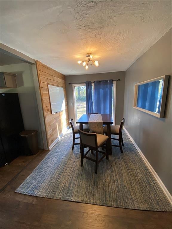 3734 Travis Blvd, Macon, GA 31206 - dining space featuring a chandelier, baseboards, wood finished floors, and a textured ceiling