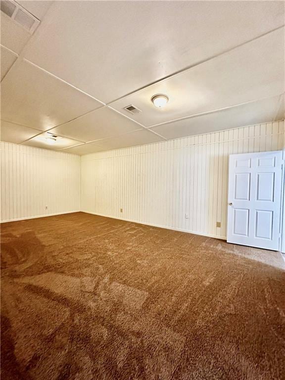 below grade area featuring visible vents and carpet floors