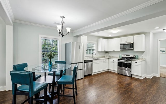 kitchen featuring dark wood-style floors, light countertops, appliances with stainless steel finishes, white cabinets, and a sink