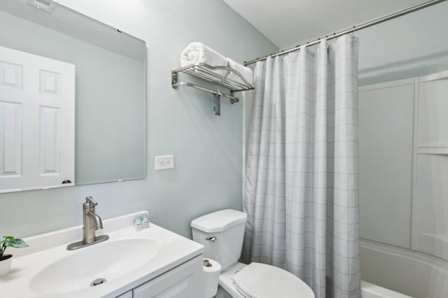 full bathroom with shower / bathtub combination with curtain, vanity, and toilet