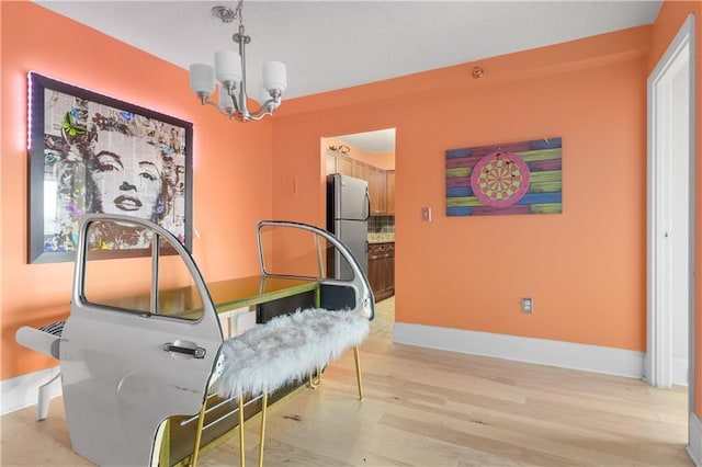 interior space featuring light hardwood / wood-style flooring and a notable chandelier