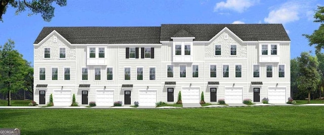 view of front of home with a garage and a front lawn