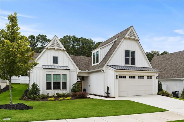 modern farmhouse style home with a standing seam roof, a front lawn, board and batten siding, and a shingled roof