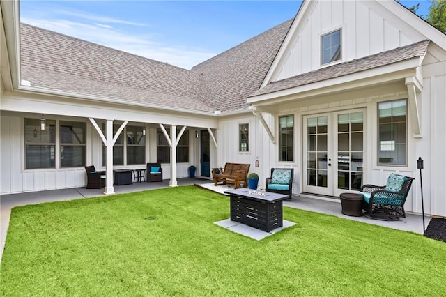 rear view of property with roof with shingles, french doors, a lawn, a patio area, and board and batten siding