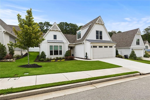 modern farmhouse featuring a front yard, driveway, a standing seam roof, board and batten siding, and metal roof