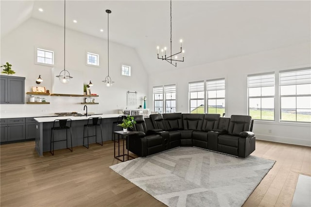 living area with recessed lighting, light wood-type flooring, and high vaulted ceiling