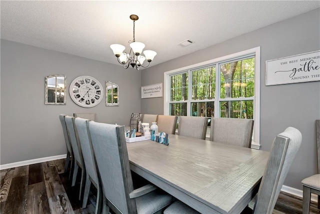 dining space featuring baseboards, visible vents, dark wood-style flooring, and a chandelier