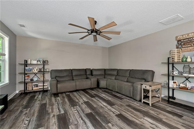 living room with visible vents, a ceiling fan, a textured ceiling, and wood finished floors