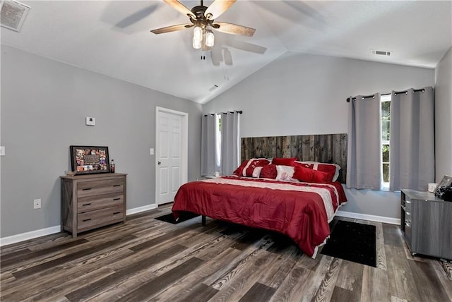 bedroom with visible vents, baseboards, wood finished floors, and vaulted ceiling