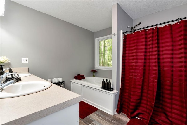 bathroom with vanity, a textured ceiling, wood finished floors, a shower with curtain, and a bath
