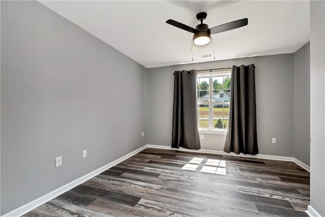 unfurnished room featuring baseboards, ceiling fan, and wood finished floors