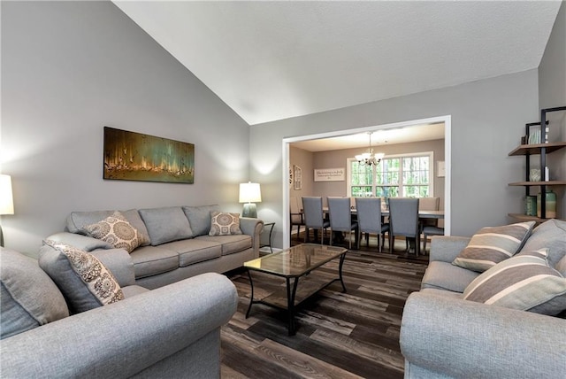 living room featuring an inviting chandelier, dark wood-style floors, and lofted ceiling
