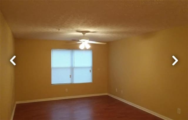 empty room with ceiling fan, dark hardwood / wood-style flooring, and a textured ceiling