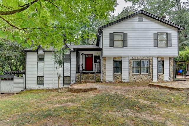 tri-level home with a front lawn