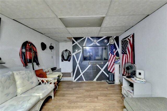 living room with wood walls, carpet, crown molding, and a textured ceiling