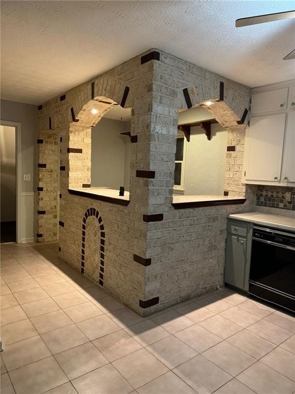 clothes washing area featuring washing machine and clothes dryer and cabinets